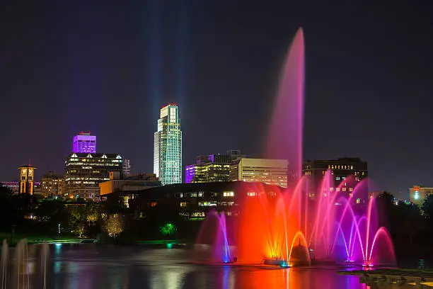 Downtown Omaha skyline with a beautifully lit fountain at night.