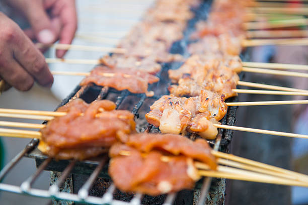 istock Roasting pork skewers on stove 586365132