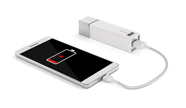 Smartphone charging with external battery Smartphone charging with power bank on white background phone charger cable stock pictures, royalty-free photos & images