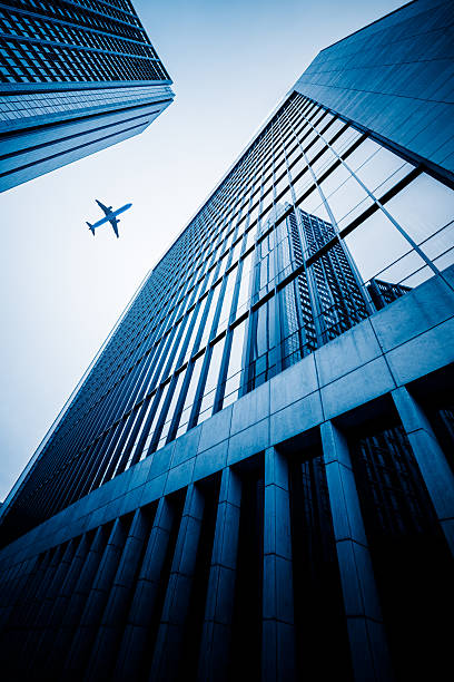 istock plane flying over the skyscrapers 586368938