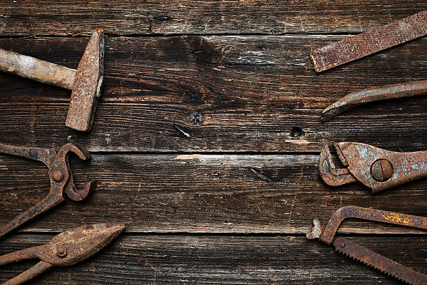 istock Old rusted tools on a wooden boards 586369820