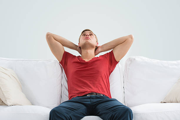 istock Portrait of handsome young man looking upwards while relaxing 586373934