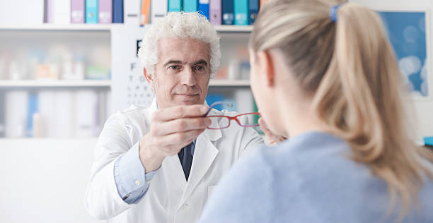 istock Ophthalmologist giving glasses to the patient 586374292