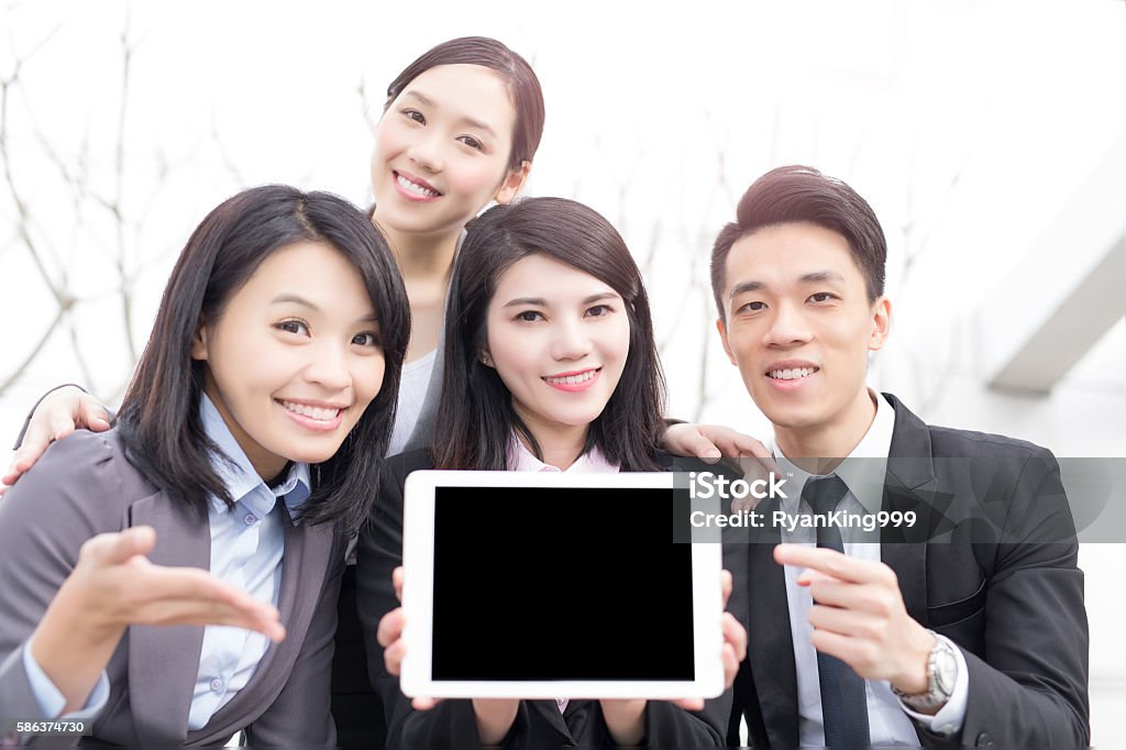 businesspeople take tablet show something businesspeople take tablet and show something in honkong, asian Adult Stock Photo