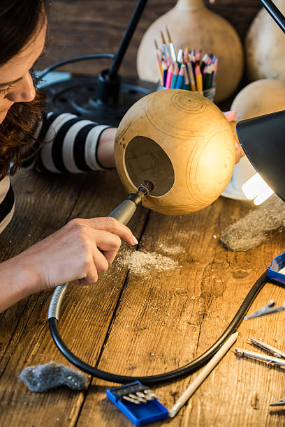 istock young woman working in artisan carving creative workshop 586374920