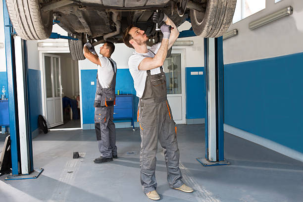 istock Mechanics working together under the car 586376414