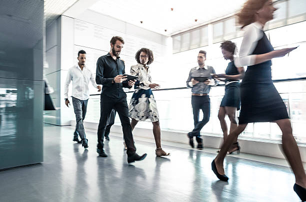 istock Business People Walking in the Lobby 586377410