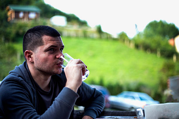 istock Handsome yooung men enjoys and drinking water in nature 586377638