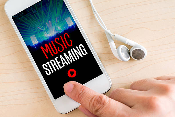 istock Hand touch smart phone and ear phone with Music Streaming 586379014