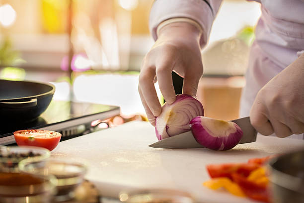 istock Knife cuts purple onion. 586380222