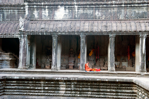 Siem Reap, Сambodia - May 18, 2016: Buddhist monk and donate box in Angkor Wat