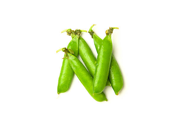 istock Pea pods and pea seeds on over white 586380584