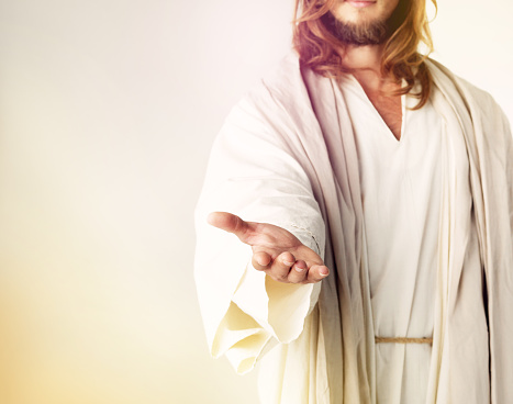 Cropped studio shot of Jesus Christ extending his arm in assistance