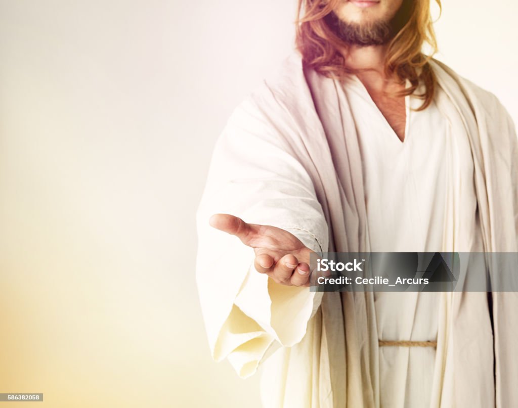 Give me your fear and I’ll give you my hand Cropped studio shot of Jesus Christ extending his arm in assistance Jesus Christ Stock Photo