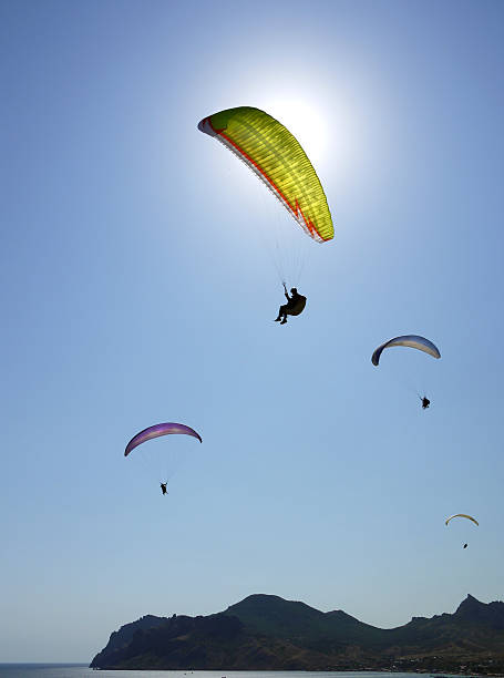 istock paragliding in the blue sky 586383884