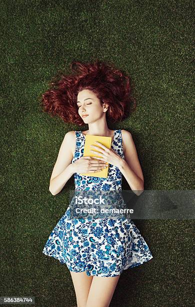 Woman Reading At The Park Stock Photo - Download Image Now - Book, Reading, Grass