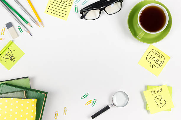 istock Office table desk with green supplies, blank note pad, cup 586388222