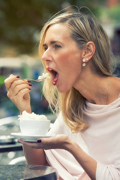 istock woman sitting outside at cafe and drinking coffee 586388318