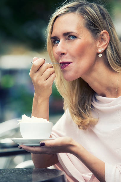 istock woman sitting outside at cafe and drinking coffee 586388416