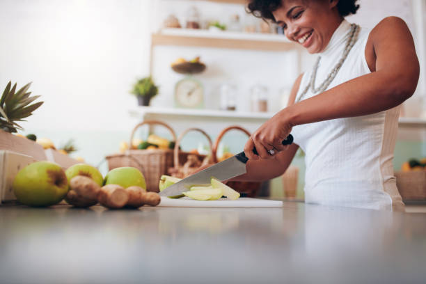 istock Young african woman making fresh juice 586390894