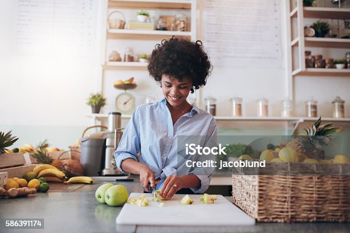 istock Young woman making fresh juice 586391174