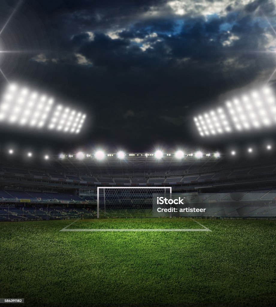 Goal Soccer ball on green stadium, arena in night illuminated bright spotlights Soccer Field Stock Photo