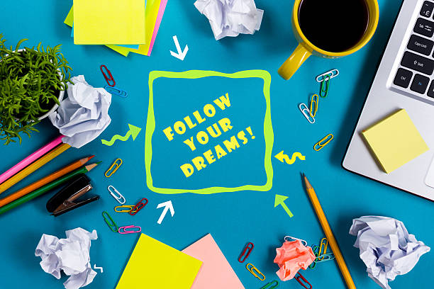 istock Follow your dreams. Office table desk with supplies, white blank 586391830