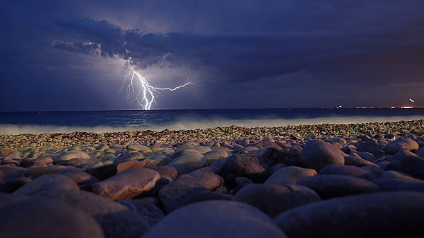Free Stock Photo of Lightning strike over a calm sea at dusk | Download ...