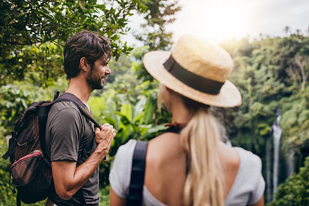 istock Young man standing with his girlfriend in forest 586393716