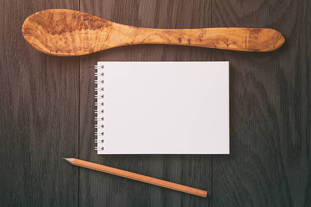 istock notepad with pencil and wood utensils on wood table 586691946
