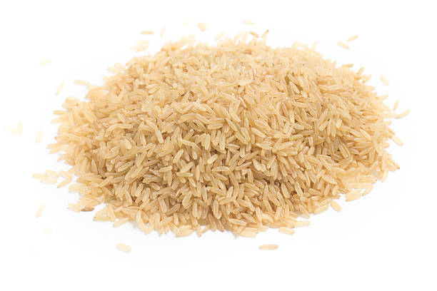istock Close-up on a Raw Brown Rice in white background 586692162