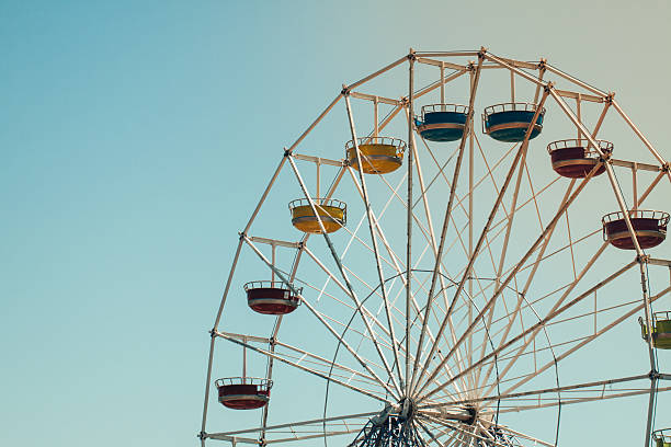 istock Vintage colorful ferris wheel over blue sky 586693274