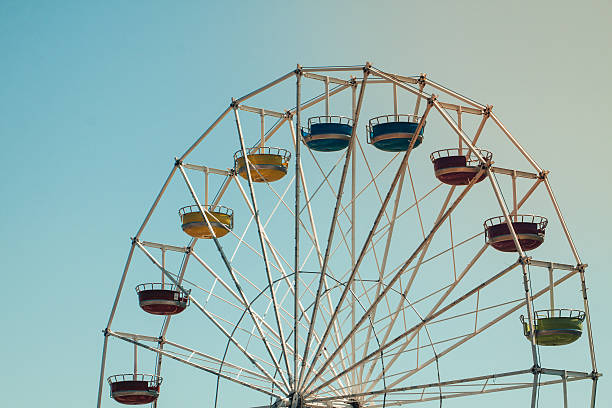 istock Vintage colorful ferris wheel over blue sky 586693368