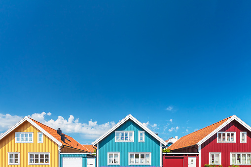 Colorful old swedish houses in front of a blue sky