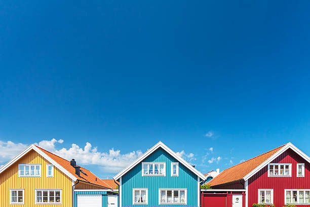 old swedish houses in front of a blue sky - red cottage small house imagens e fotografias de stock