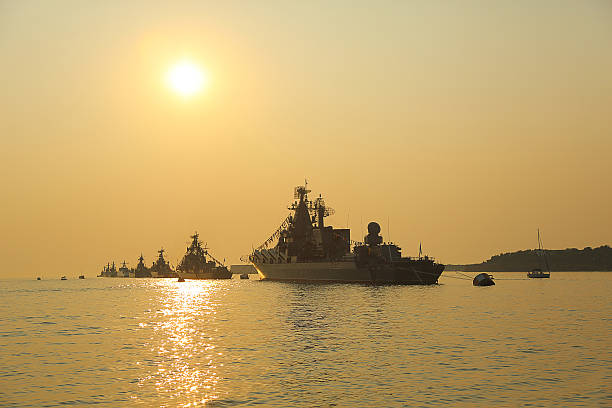 istock silhouette of military ships on sunset 586696360