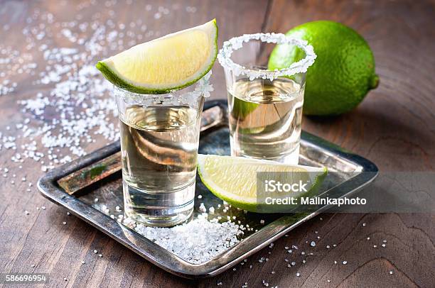 Tequila Gold Mexican Alcohol In Shot Glasses Stock Photo - Download Image Now - Tequila - Drink, Alcohol - Drink, Alcohol Abuse