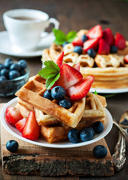 istock Belgian waffles with strawberries, blueberries and syrup 586697080