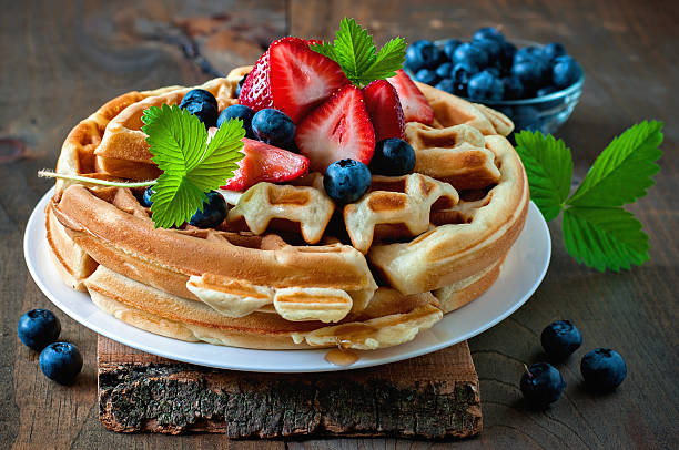 istock Belgian waffles with strawberries, blueberries and syrup 586697282