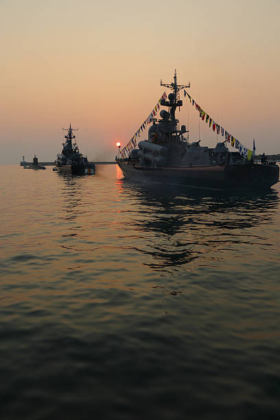 istock silhouette of military ships on sunset 586698142