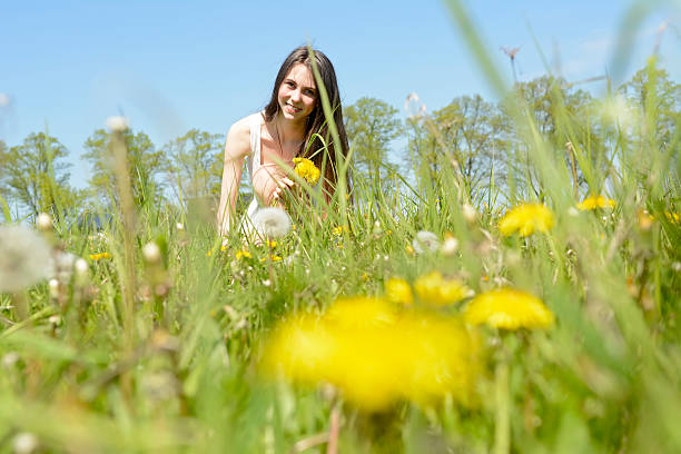 istock happy woman with dandelions 586698488