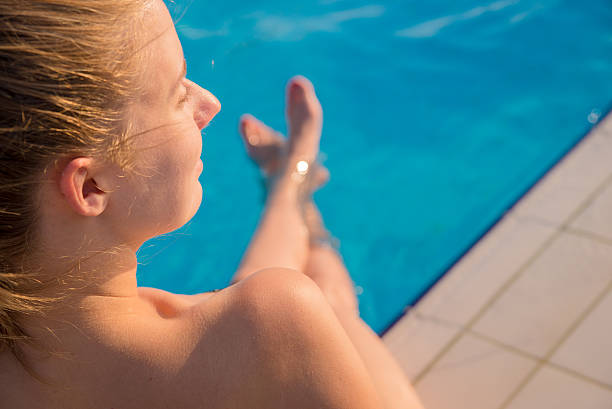 istock woman relaxing at poolside on summer vacation 586699786