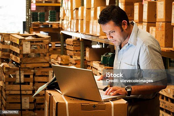 Hispanic Manager In Warehouse Stock Photo - Download Image Now - Small Business, Business, Owner