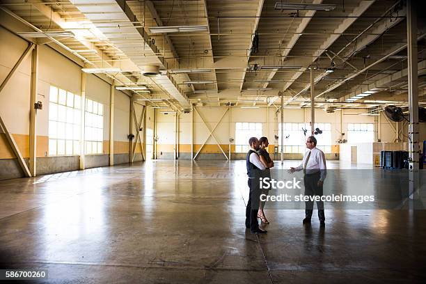 Meeting In Empty Office Warehouse Stock Photo - Download Image Now - Warehouse, Empty, Moving Office