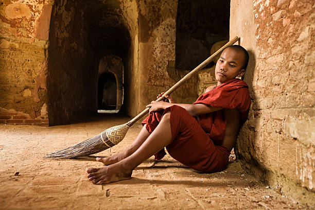 istock Novice Buddhist monk resting inside the temple. Myanmar 586700550