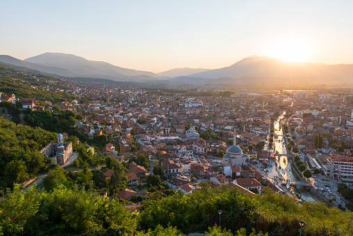 Sunset over the historic city of Prizren, Kosovo. The river is the Prizrenska Bistrica, and a mosque and church are both visible on the left side of the river.