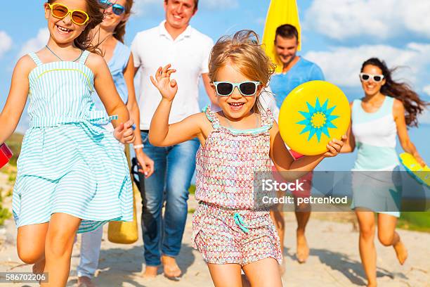 Multiracial Group Of Friends Walking At The Beach Stock Photo - Download Image Now - Family, Beach, Summer
