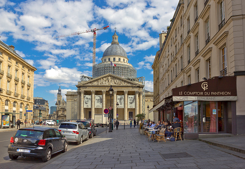 Paris, France - July 30, 2015:  Rue Soufflot with people sitting an restaurant and famous Pantheon on the background