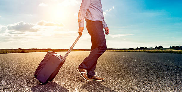 istock Passenger walks with suitcase outside on airfield 586704120