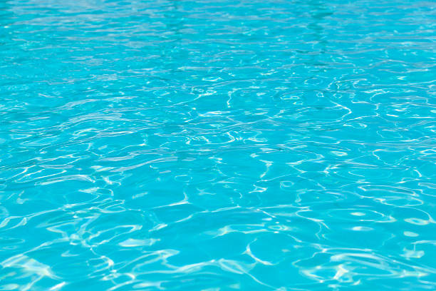 swimming pool water texture background defocused shallow tiled swimming pool background. shallow stock pictures, royalty-free photos & images